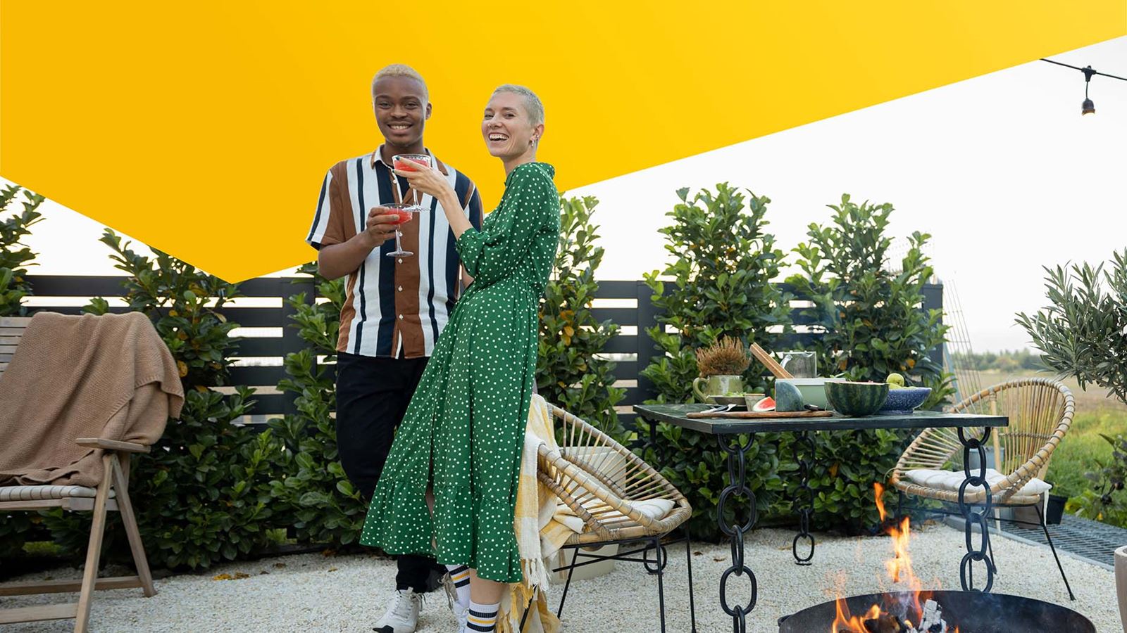 A couple celebrating in the garden (with a yellow design element above)