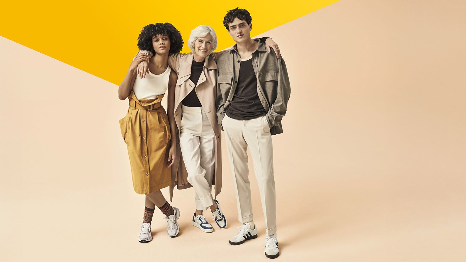 Three fashionable people on a peach pink background (with overlying yellow design element)